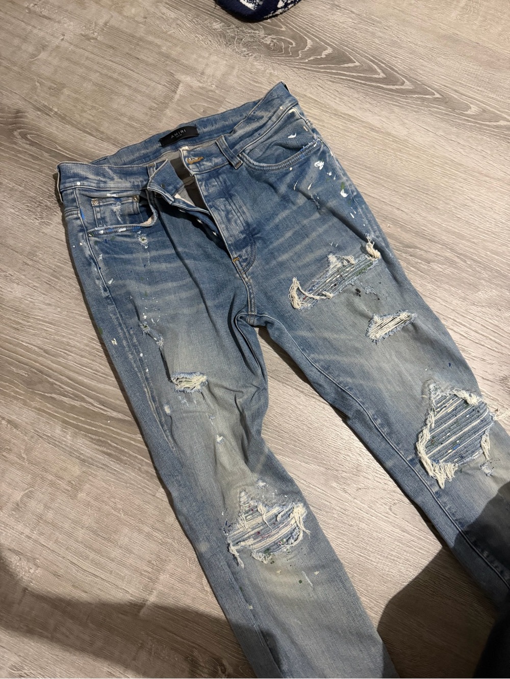 Amiri Paint Splatter Light Wash Ripped Jeans